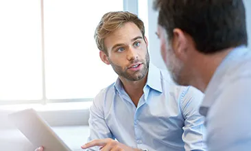 Photo of two men in conversation